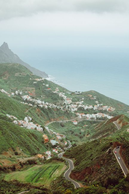 Captivating view of lush green hills leading to the ocean in Santa Cruz de Tenerife, Spain.
