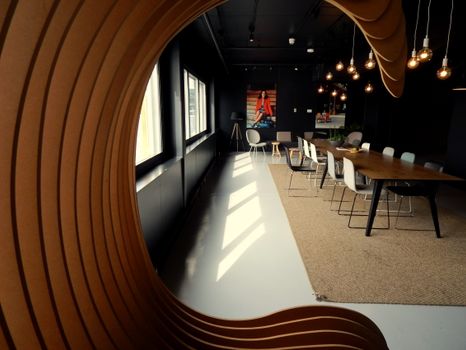 Stylish conference room featuring a modern interior design with unique wood paneling and natural lighting.