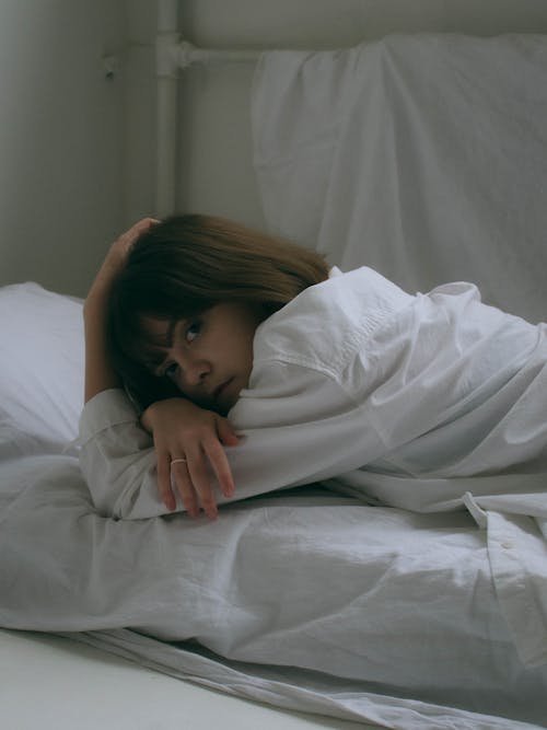 Free A Woman Lying on Bed  Stock Photo