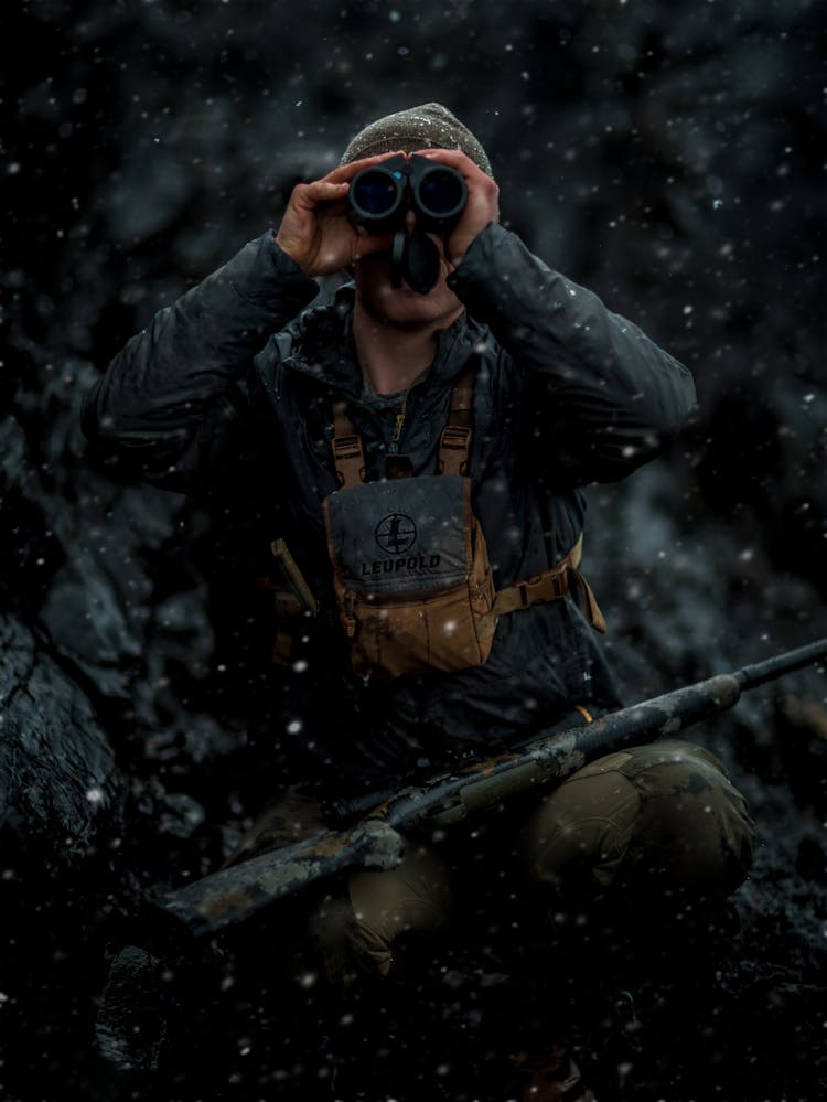 Hunter With Binoculars And Rifle