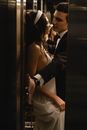 Man in Black Suit Jacket Kissing Woman in White Dress