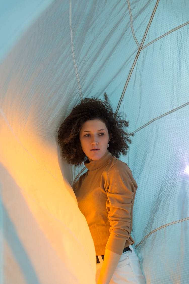 A Woman Posing Inside A Tent