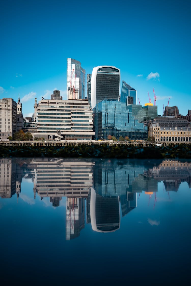 Reflection Of Business District In Water Surface