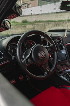 High-quality car interior featuring a sleek leather steering wheel and modern dashboard.