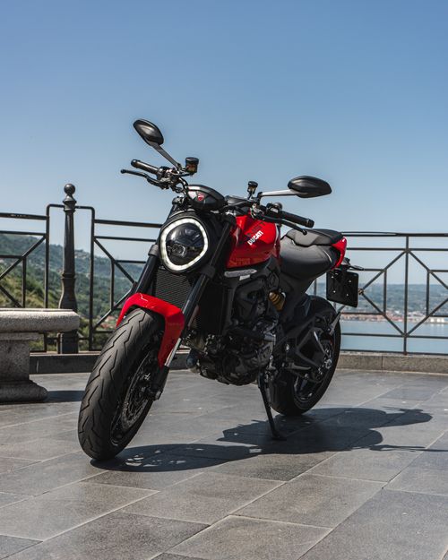 Free Red Ducati motorcycle parked outdoors with a scenic backdrop, showcasing luxury and power. Stock Photo