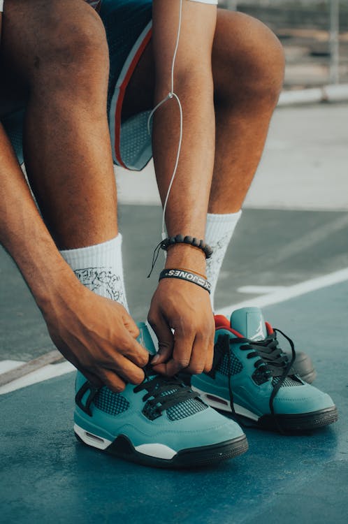 Free Close-up of Person Tying up Running Shoes Stock Photo
