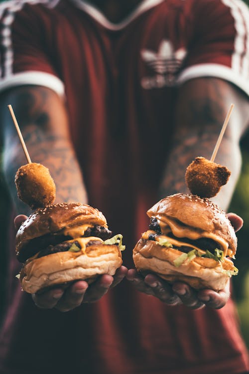Free Person Holding Two Hamburgers Stock Photo