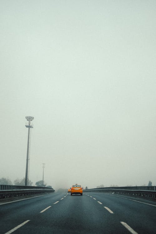 Free Yellow Car on the Road Stock Photo