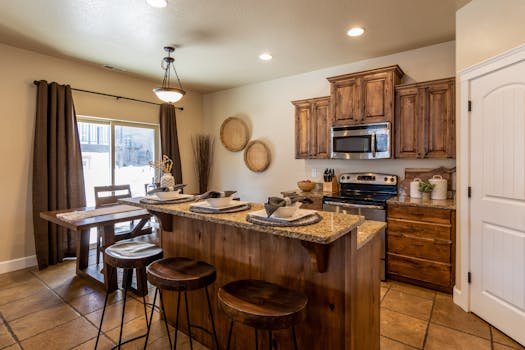 A cozy, modern rustic kitchen featuring wooden cabinets and a central island with seating, designed for comfort and style.