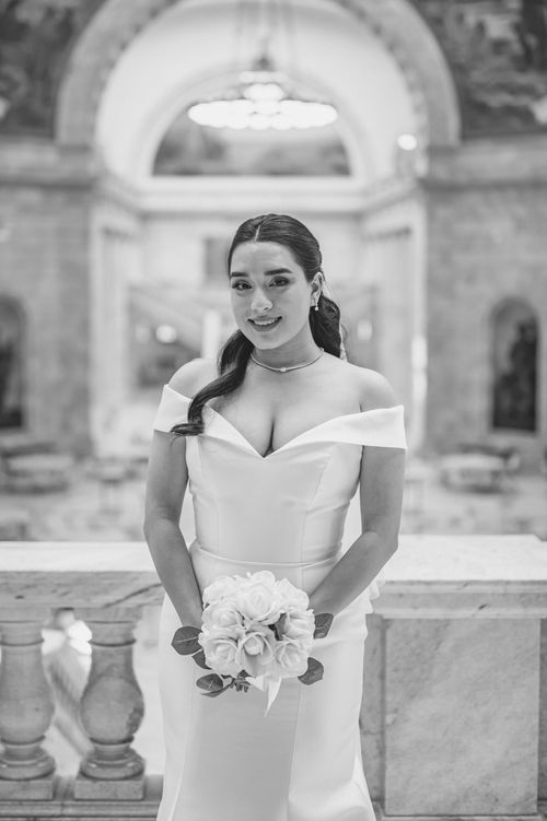 Free Black and white portrait of a bride holding flowers in a cathedral. Stock Photo