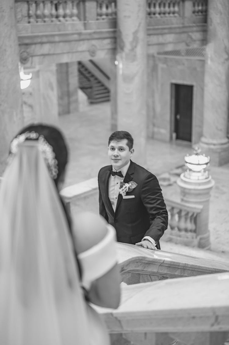 Bridegroom Watching His Bride On A Staircase