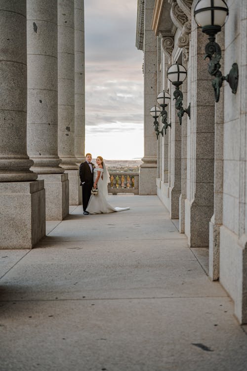 A Newlywed Couple Standing in Front of a Building
