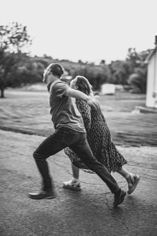 Free Dynamic black and white image of a couple running together outdoors, showcasing motion and energy. Stock Photo