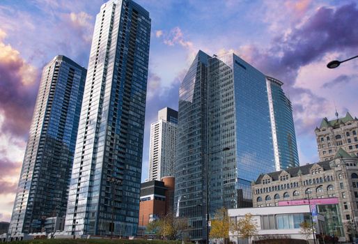 Stunning view of Montreal's skyscrapers in a dramatic sky, showcasing urban architecture.