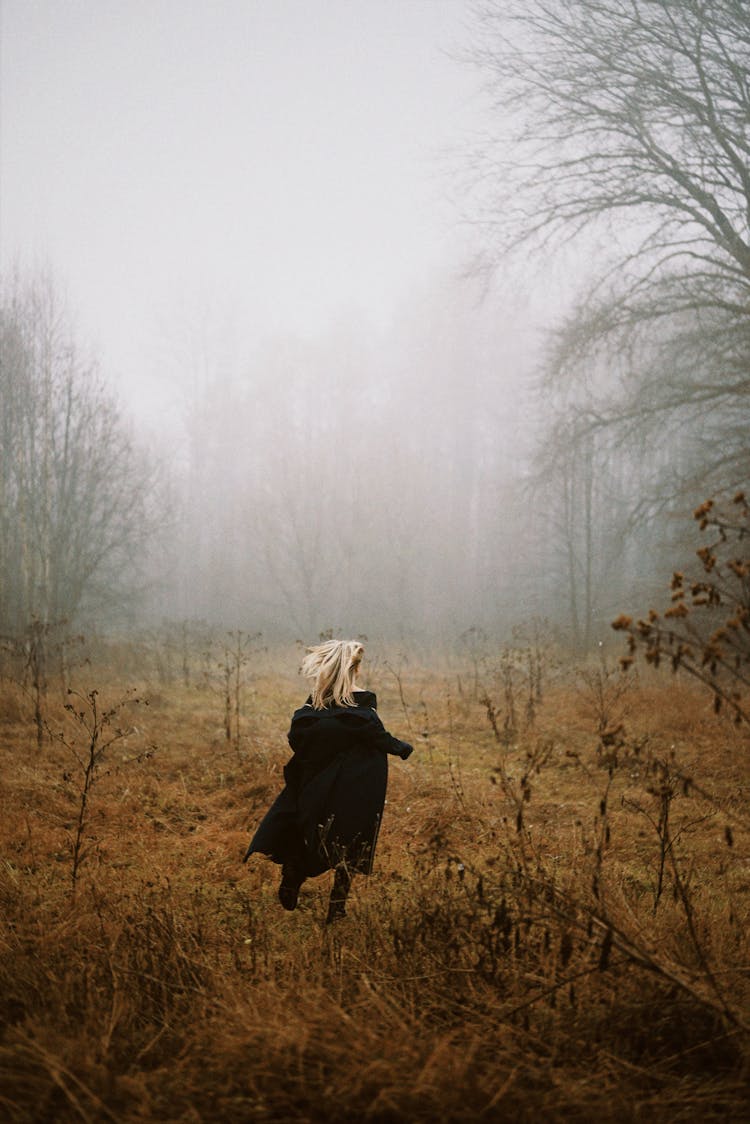 A Woman Running In The Woods