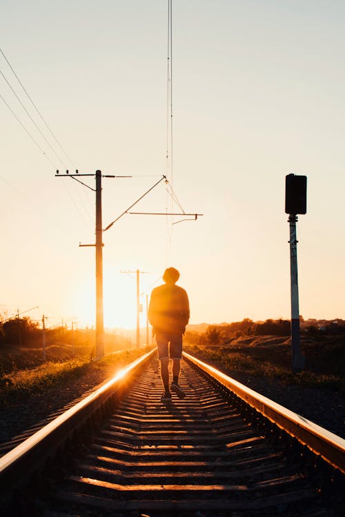 A Person Walking on the Train tracks · Free Stock Photo