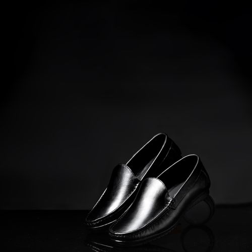 Free Stylish and formal black leather loafers in a sleek and classic design, ideal for fashion statements. Stock Photo