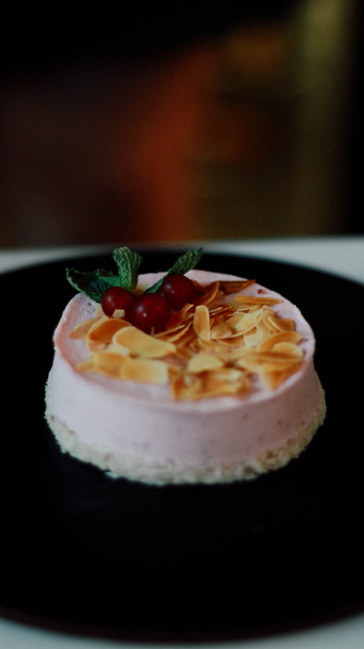 Close-up Of A White Cake With Cherries