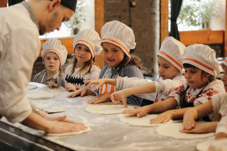 Children Learning To Make Pizza