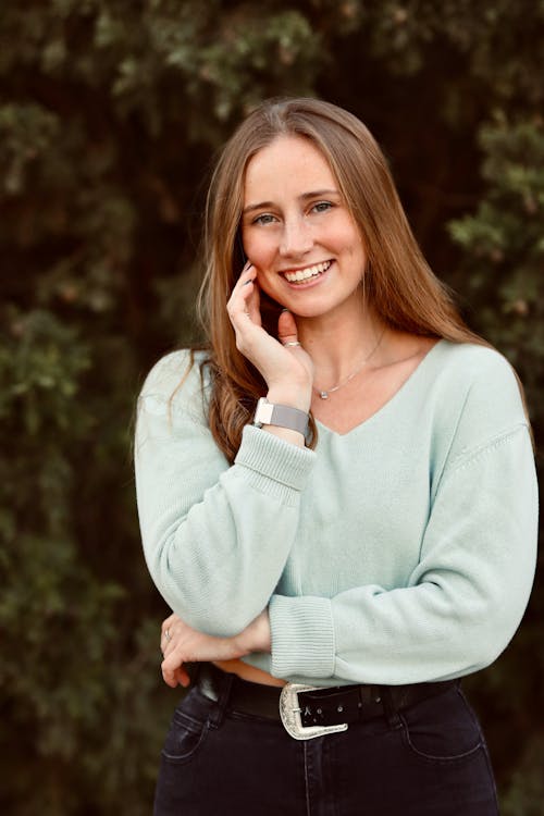 Woman in Knitted Sweater Smiling at the Camera