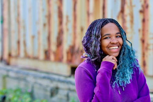 A Happy Woman with Colorful Hair Smiling at the Camera