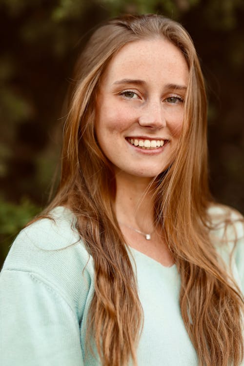 A Happy Woman with Long Hair Smiling at the Camera