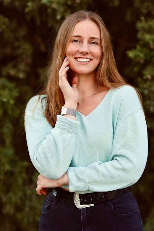 A Woman's Hand on Her Chin Smiling at the Camera