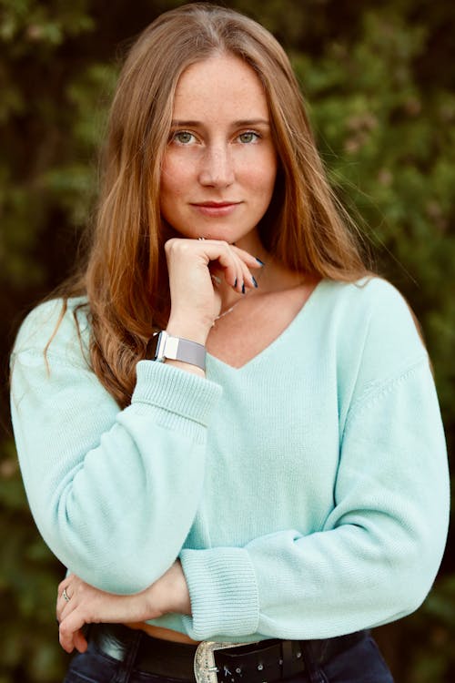 Beautiful Woman in Blue Sweater with Hand on Chin