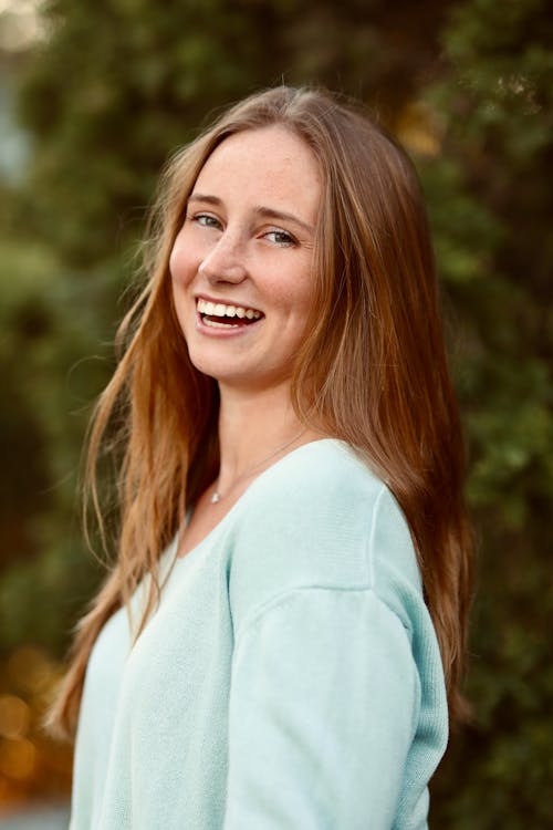 A Happy Woman Wearing Knitted Sweater