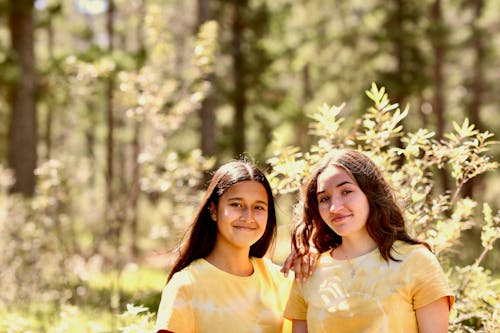 Friends in Yellow Shirts Posing in the Forest