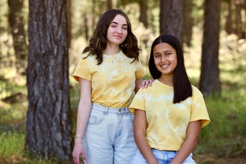 Smiling Women Wearing Matching Outfits 