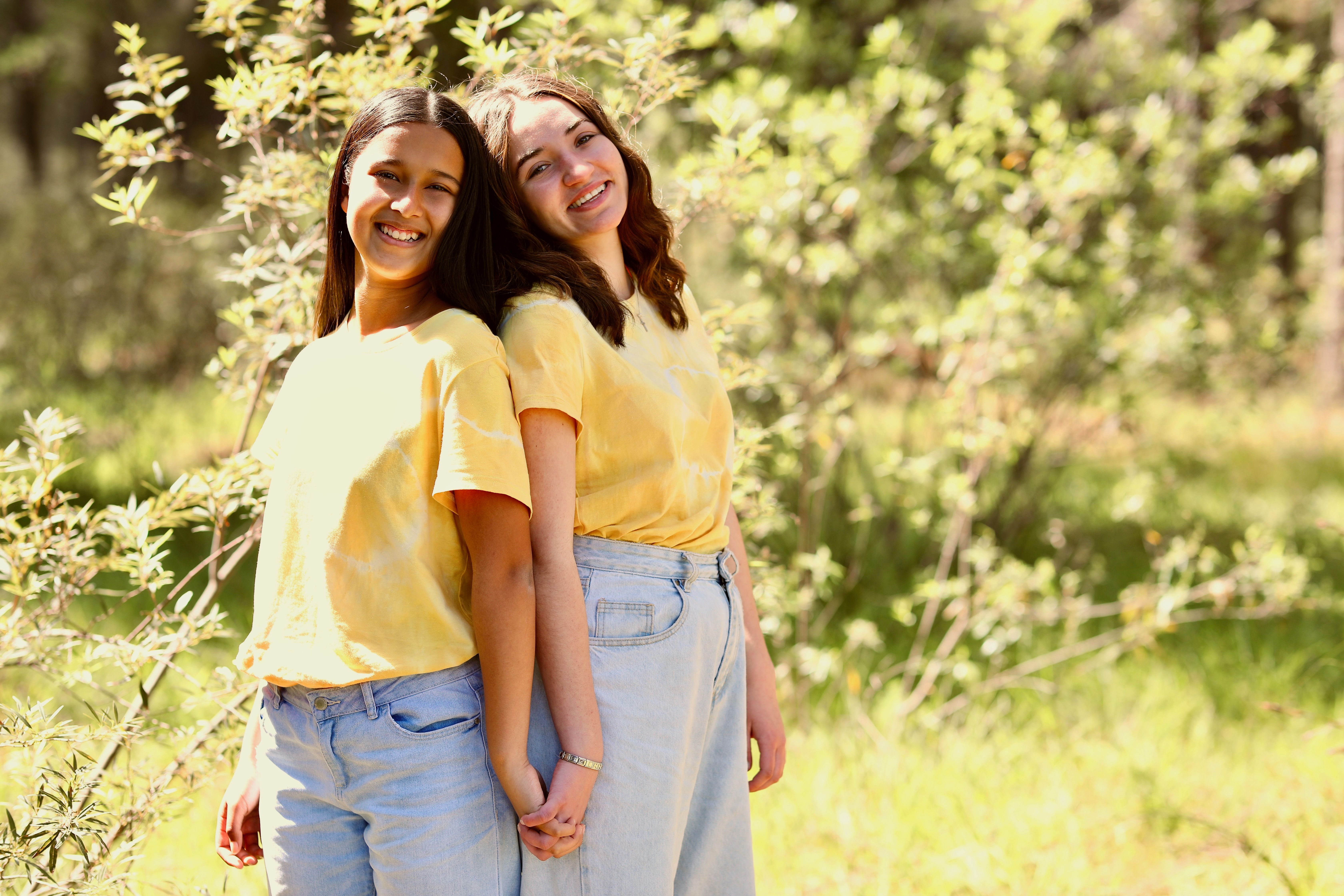 Women in School Uniform Standing on Green Grass Near the Tree · Free