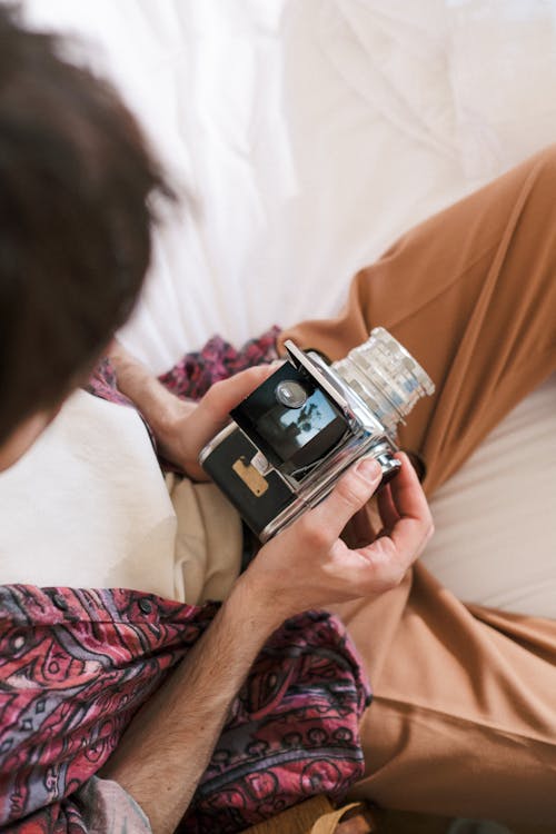 Unrecognizable Man Looking into Box Camera and Focusing on Object