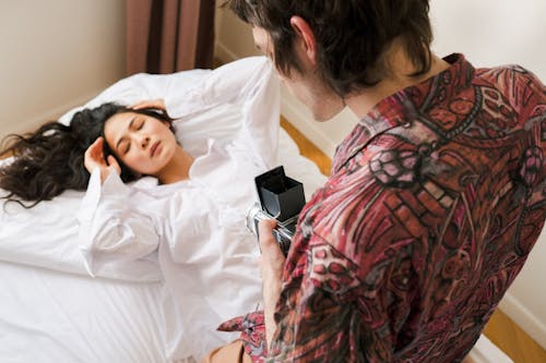Free Man Filming Woman on Bed Stock Photo