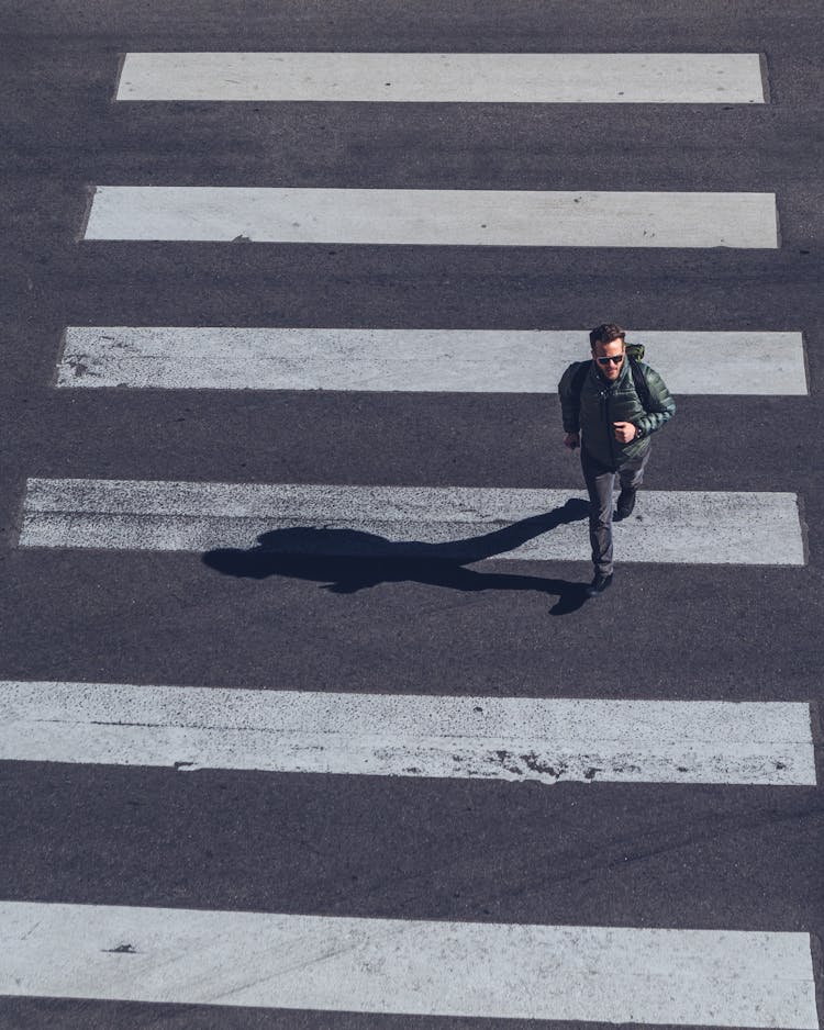 Man Crossing On Pedestrian Lane