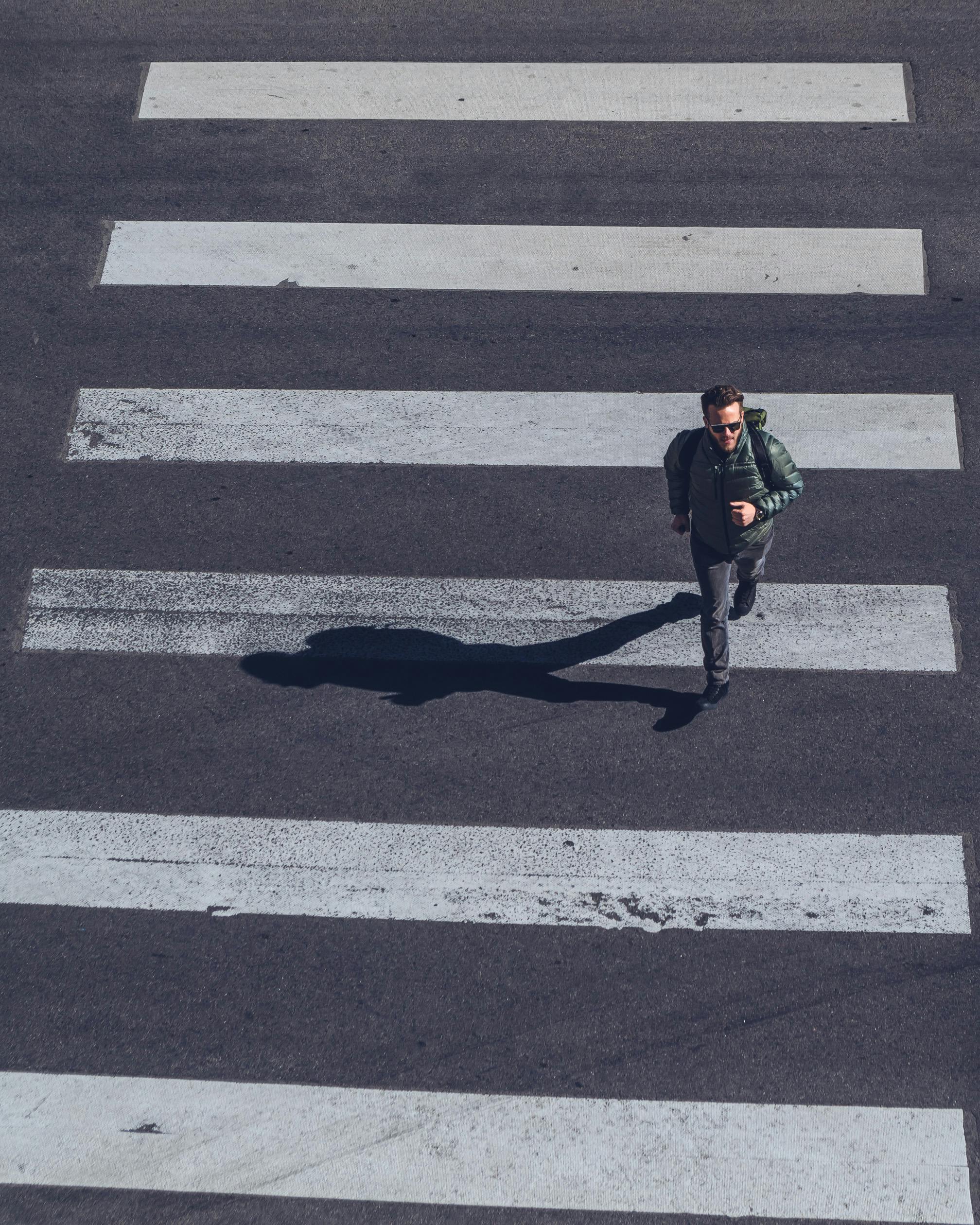 Man Crossing on Pedestrian Lane