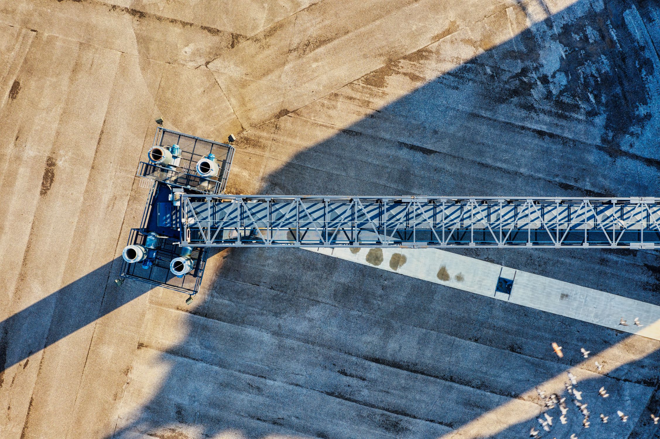 Aerial View of a Crane and Machinery on a Field · Free Stock Photo