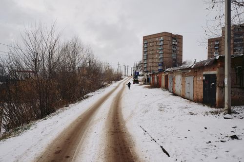 Free Snowy urban street with high-rise residential buildings on a winter day. Stock Photo