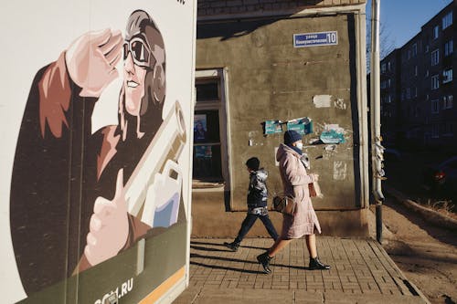 Side View of a Woman Walking in an Alley