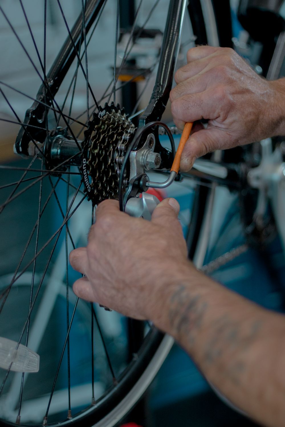 Hands servicing bicycle drivetrain components with a repair tool