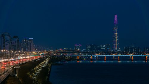 Free Stunning nighttime view of Seoul cityscape with Lotte Tower and Han River. Stock Photo