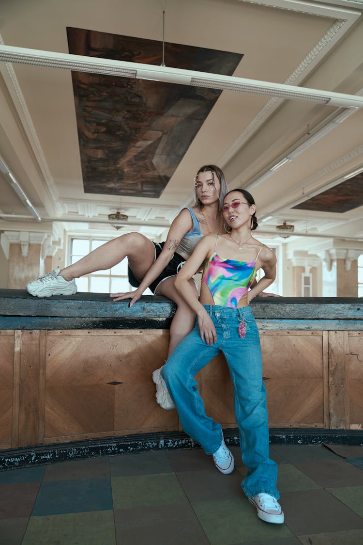 Women Wearing Tank Tops Leaning On A Counter