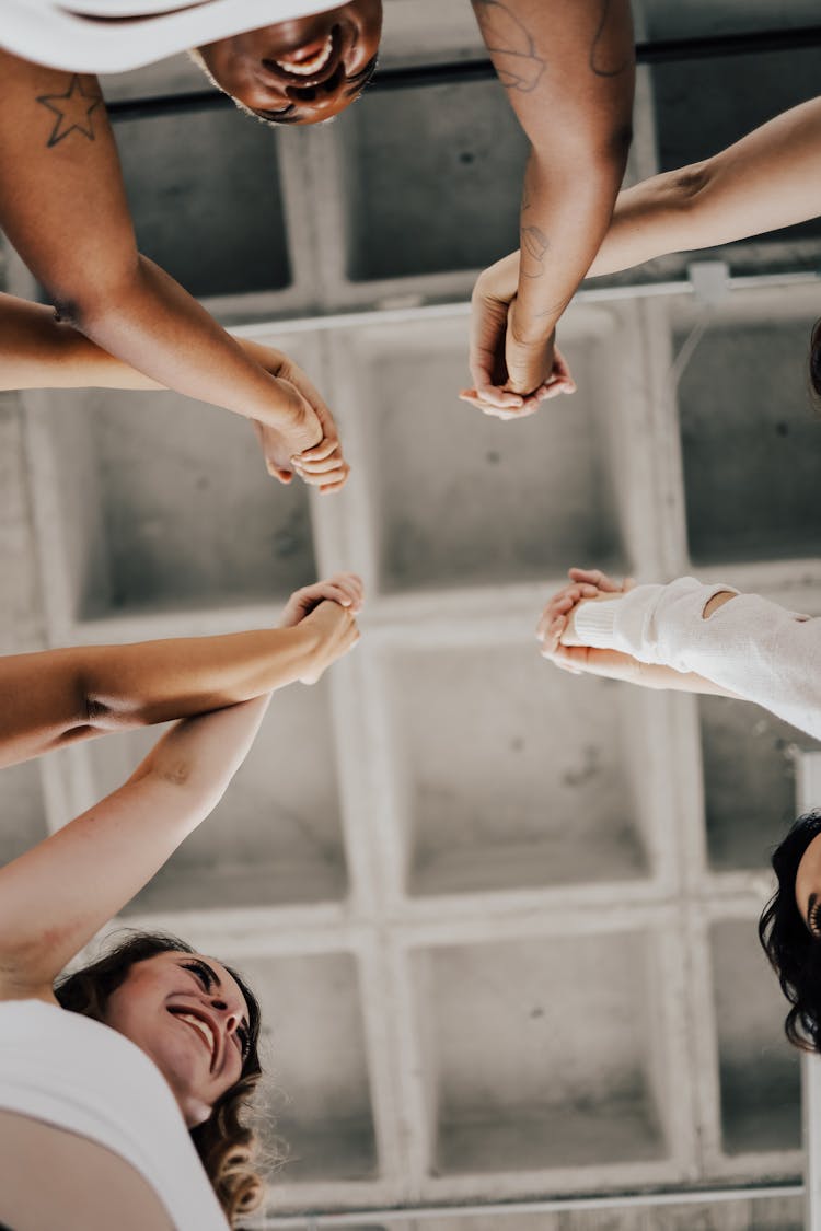 Women Cheering And Holding Hands