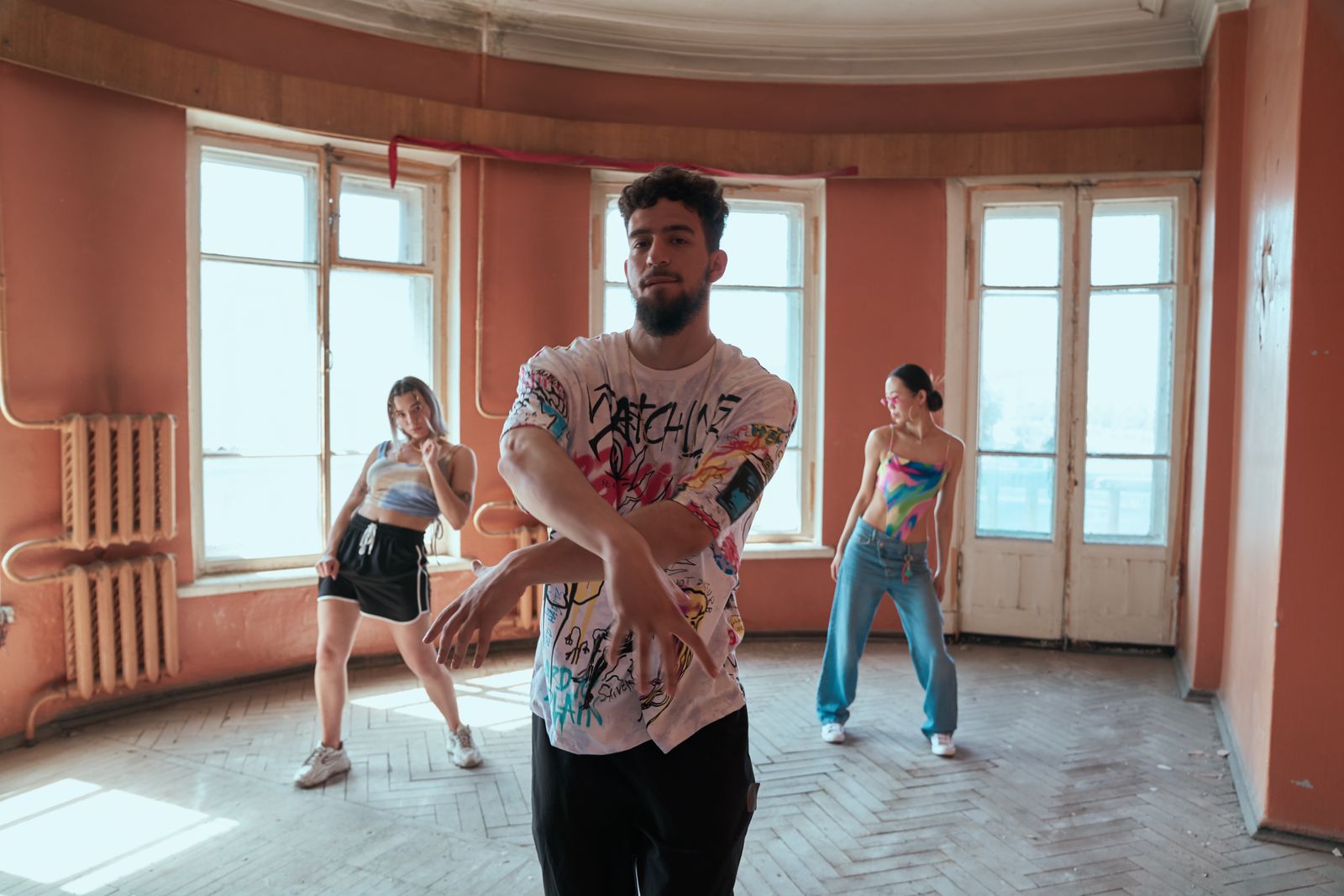 Dancer performing high-energy, hip-driven reggaeton movement