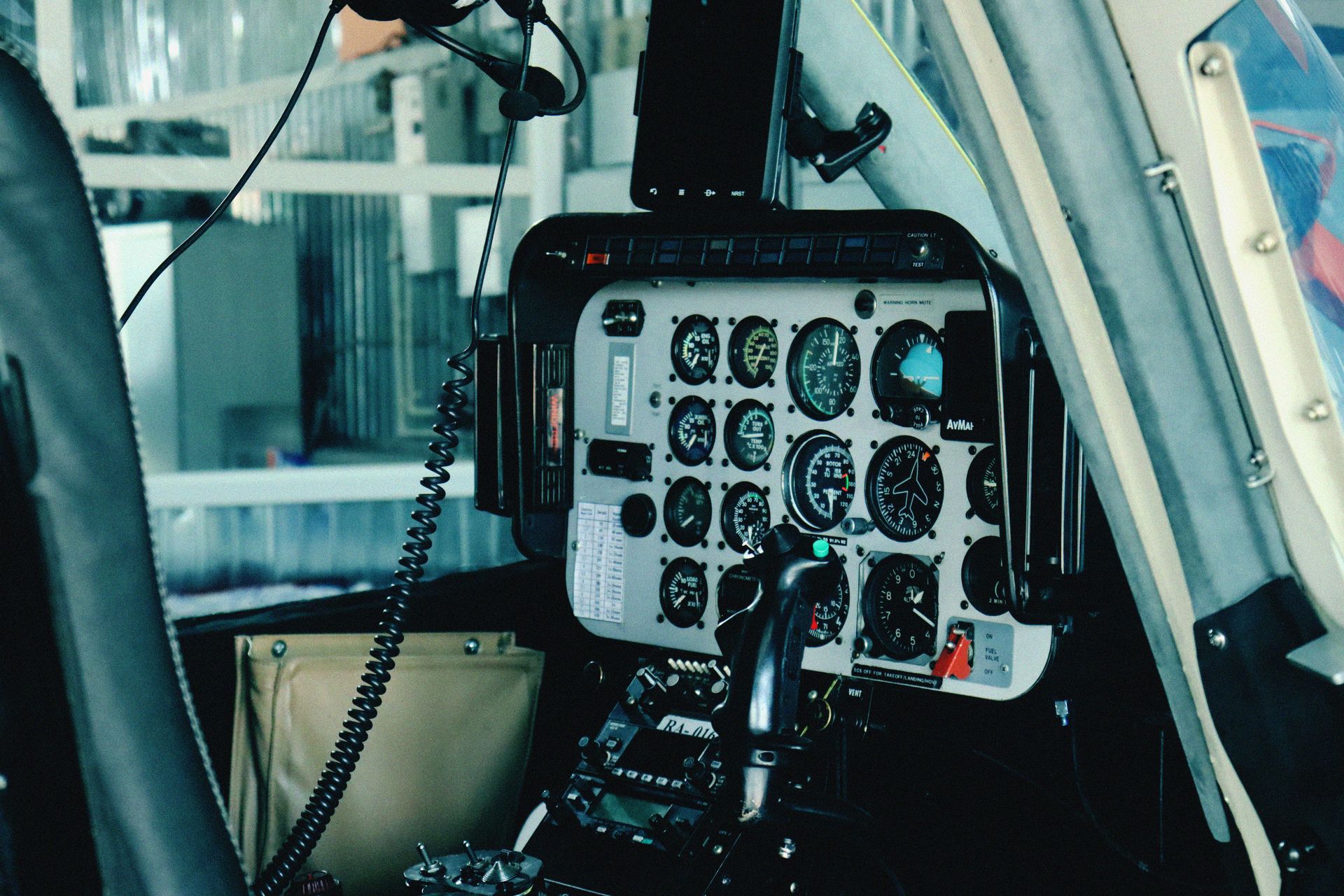Detailed view of a helicopter's cockpit control panel with various gauges and navigational instruments.
