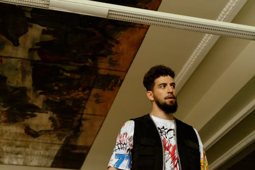 A Bearded Man in a Vest and Printed Shirt