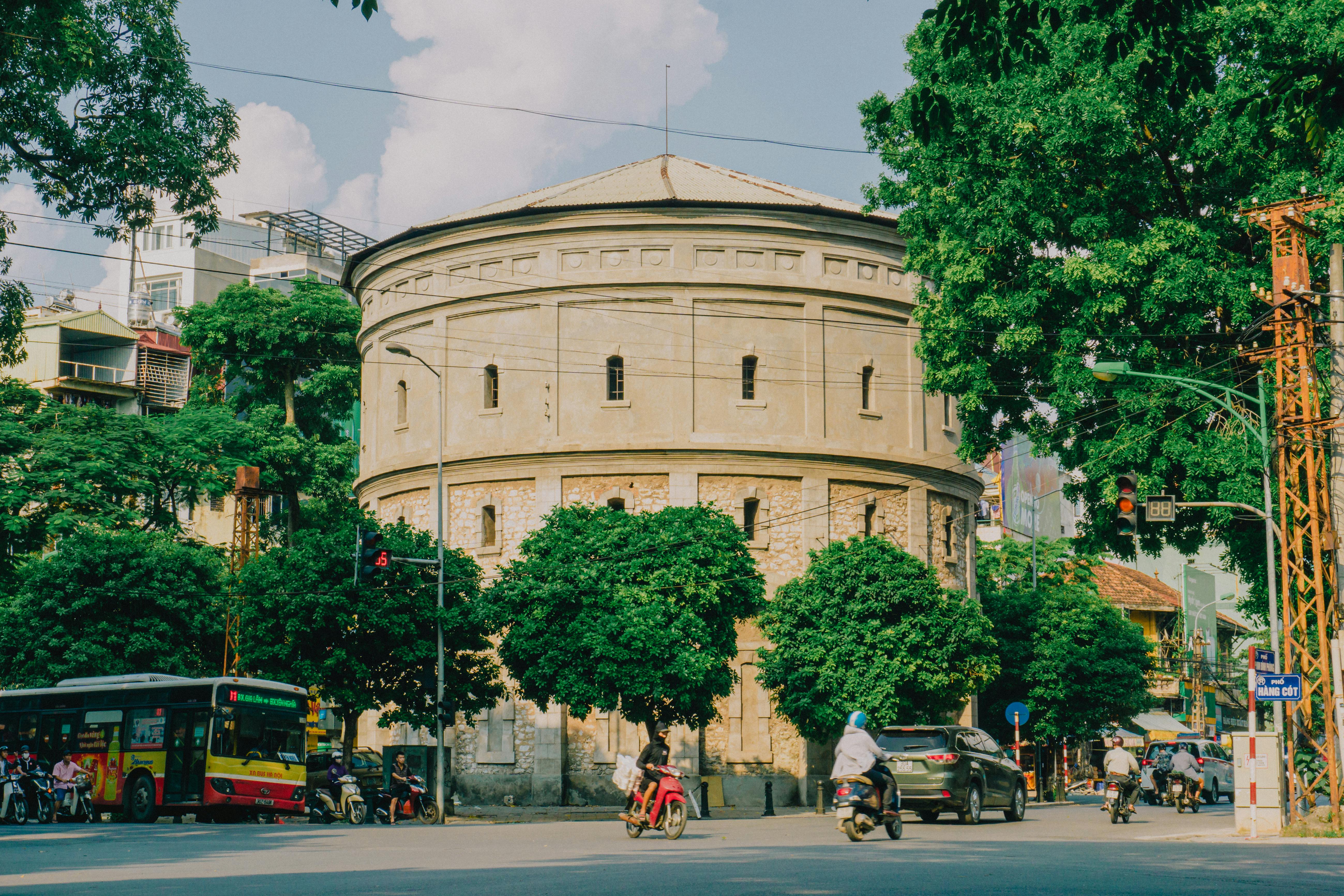 Street view of Hang Dau Water Tank in Hanoi, Vietnam, showcasing urban life and historic architecture.