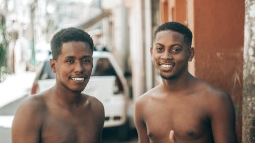 Free Selective Focus Photo of Two Topless Men Smiling  Stock Photo