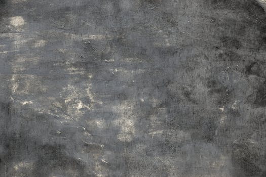 High-resolution image of a rough gray concrete texture, perfect for background use.