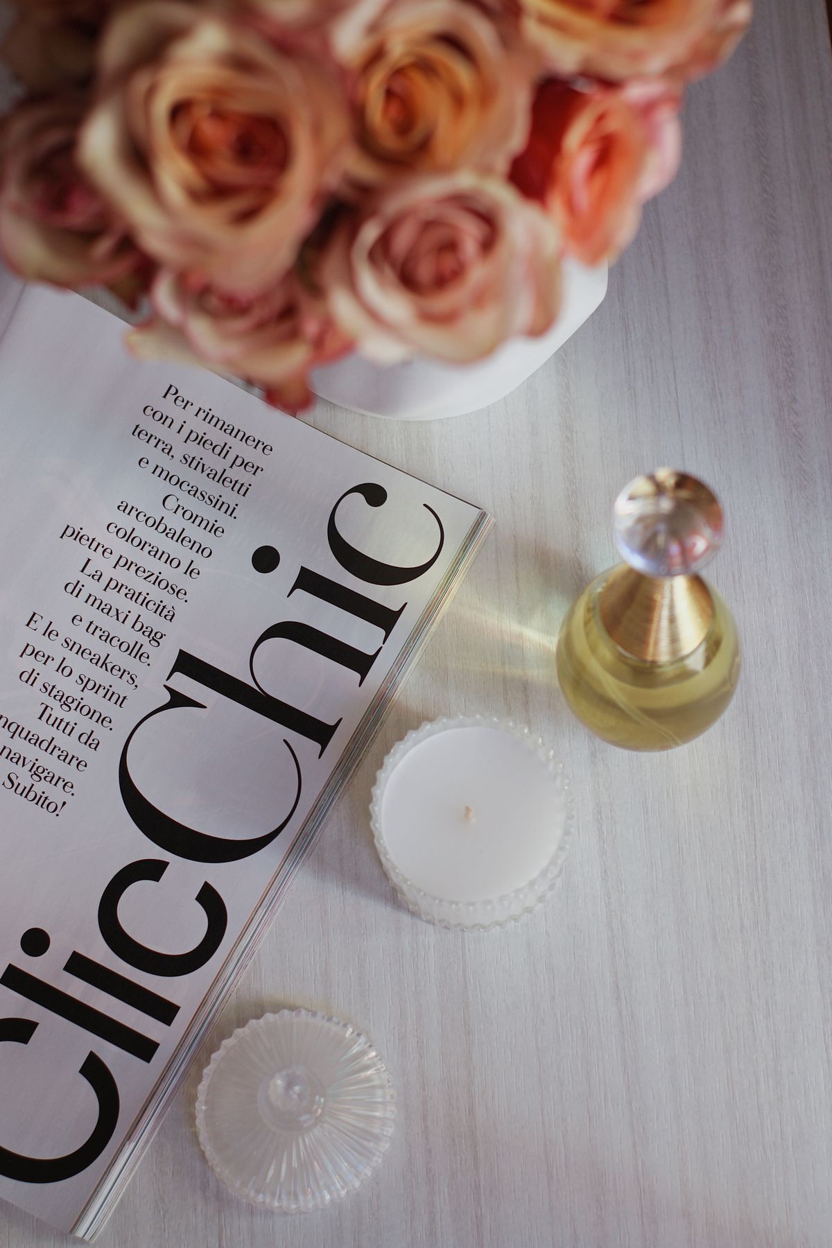 Ember No. 4 styled on a table with roses and a magazine